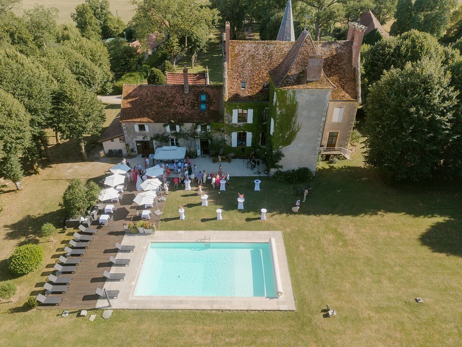 An aerial view of a reception in the park behind the château